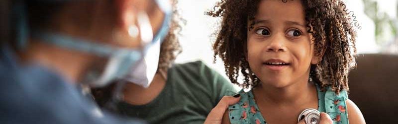 nurse checking child patient's heartbeat