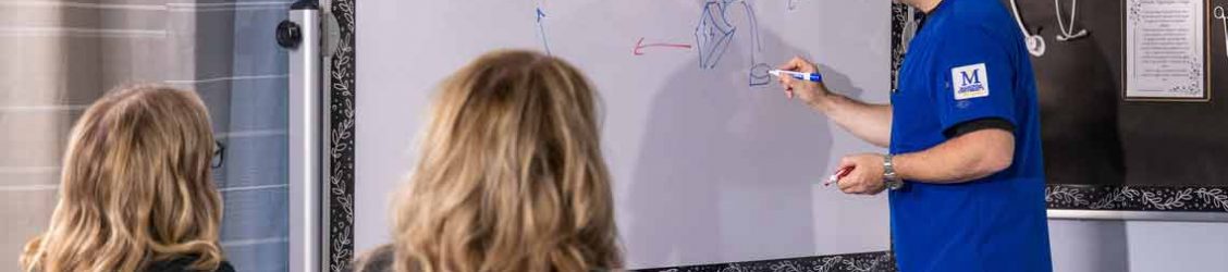 nursing student writing on a white board